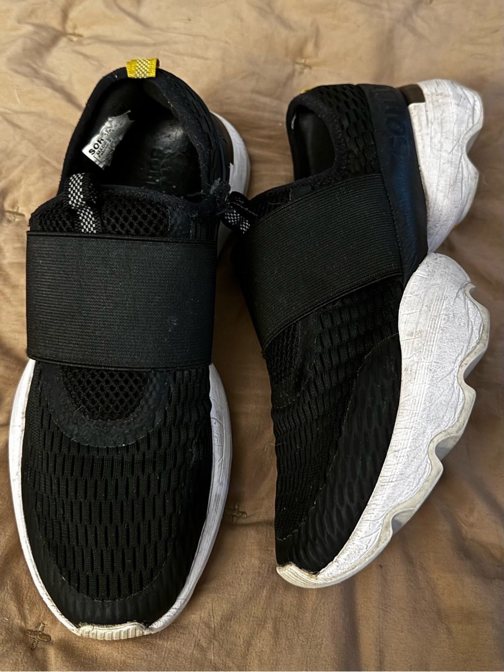 Sorel Black Slip-On Athletic Sneakers with White Soles and Yellow Heel Tab